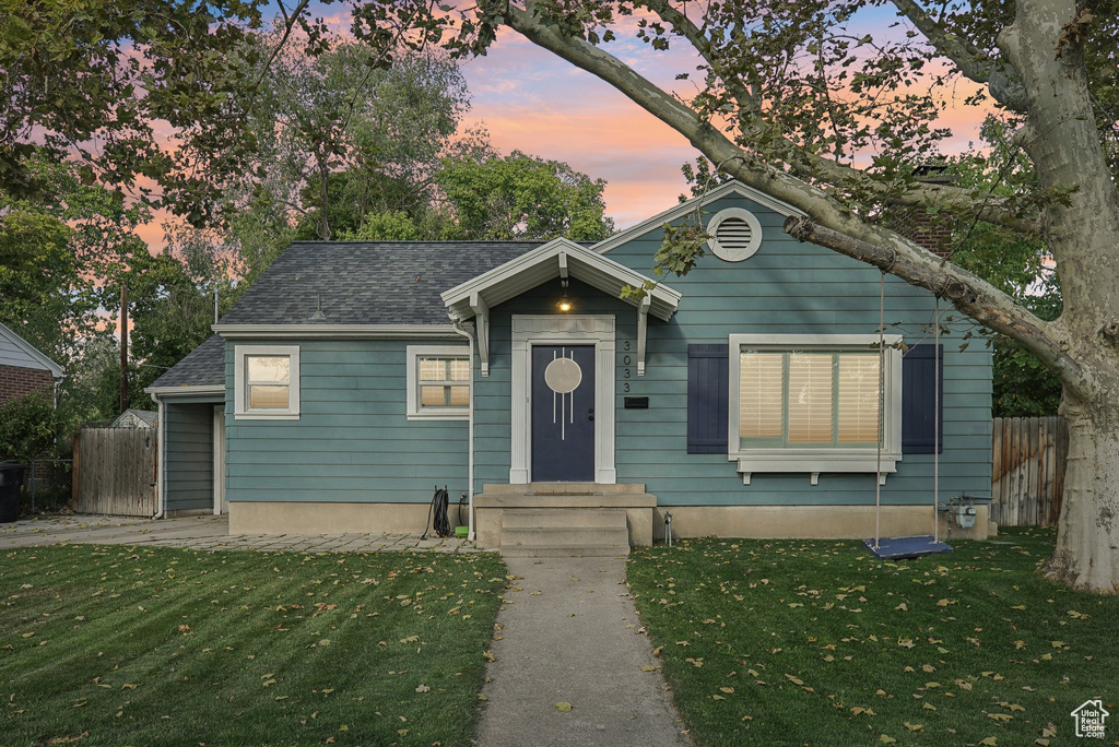 Bungalow-style house featuring a yard