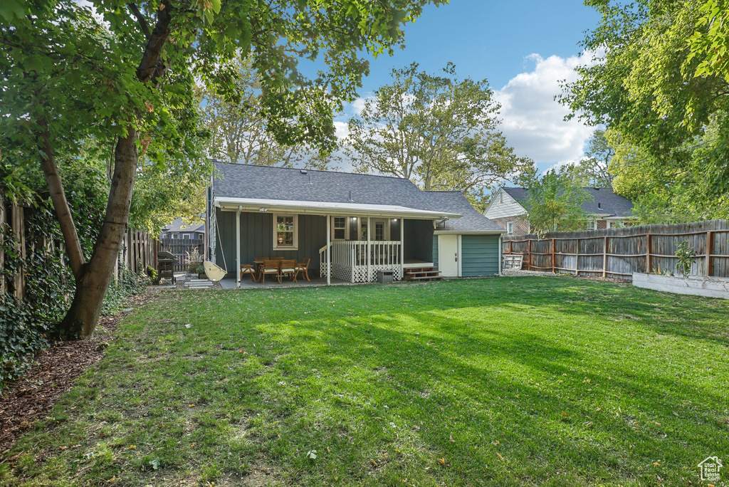 Rear view of house featuring a lawn and a patio