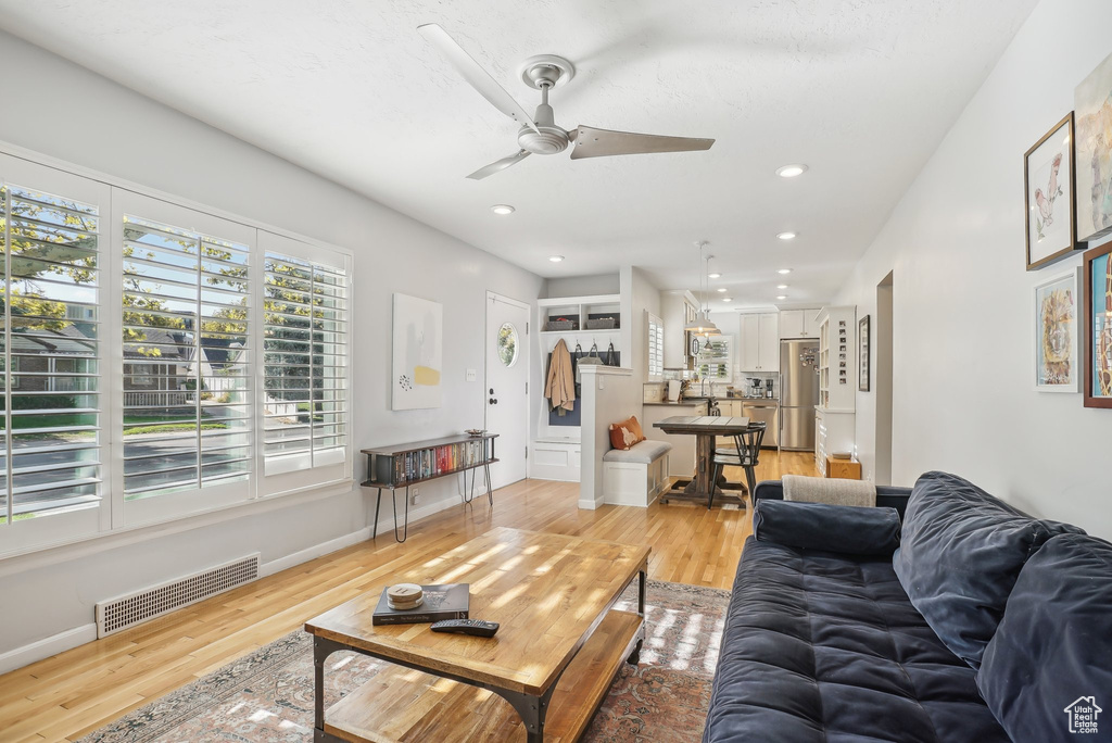 Living room featuring light hardwood / wood-style flooring and ceiling fan