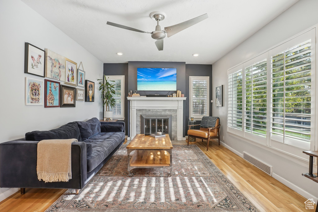 Living room featuring hardwood / wood-style floors and ceiling fan