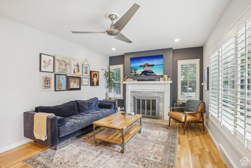 Living room featuring ceiling fan and hardwood / wood-style floors