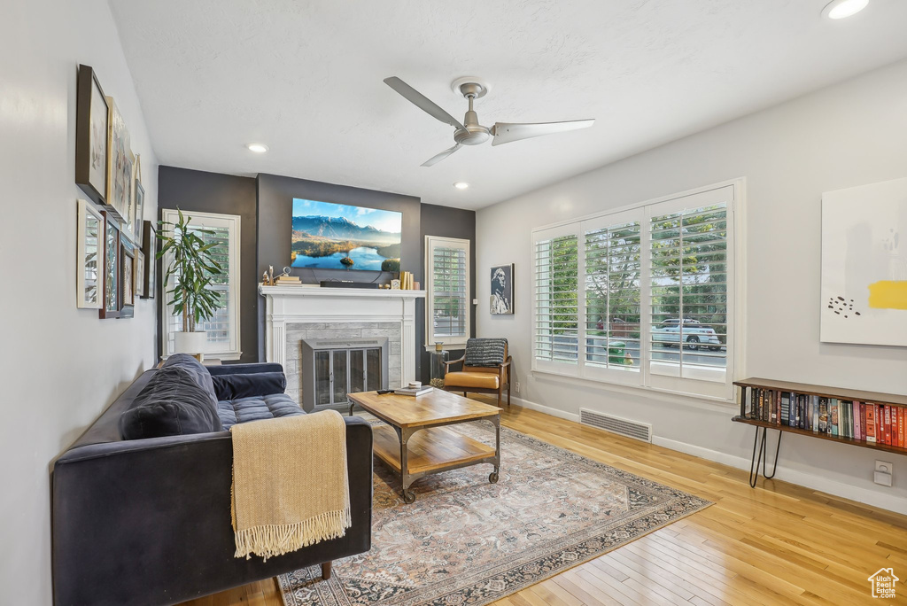 Living room with hardwood / wood-style floors and ceiling fan