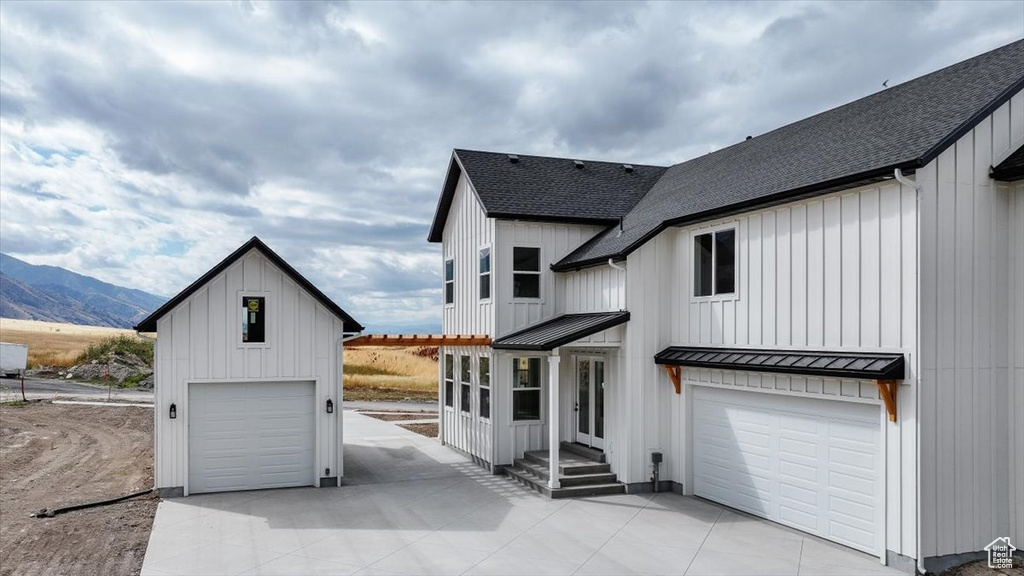 View of front of house with a garage and a mountain view