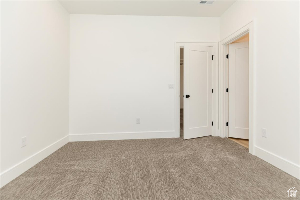 Unfurnished room with light colored carpet