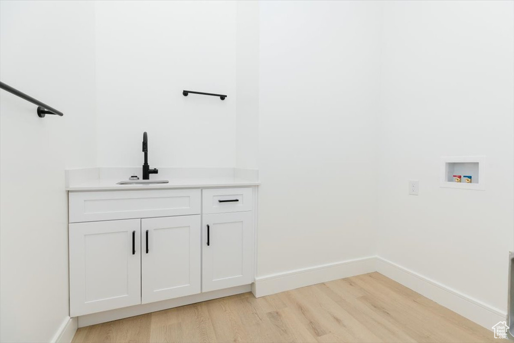 Bathroom with hardwood / wood-style flooring and vanity