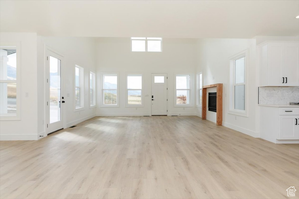 Unfurnished living room with light hardwood / wood-style floors