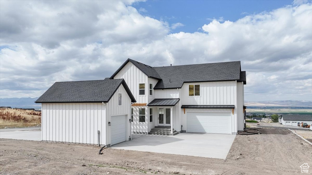 Modern inspired farmhouse with a mountain view and a garage