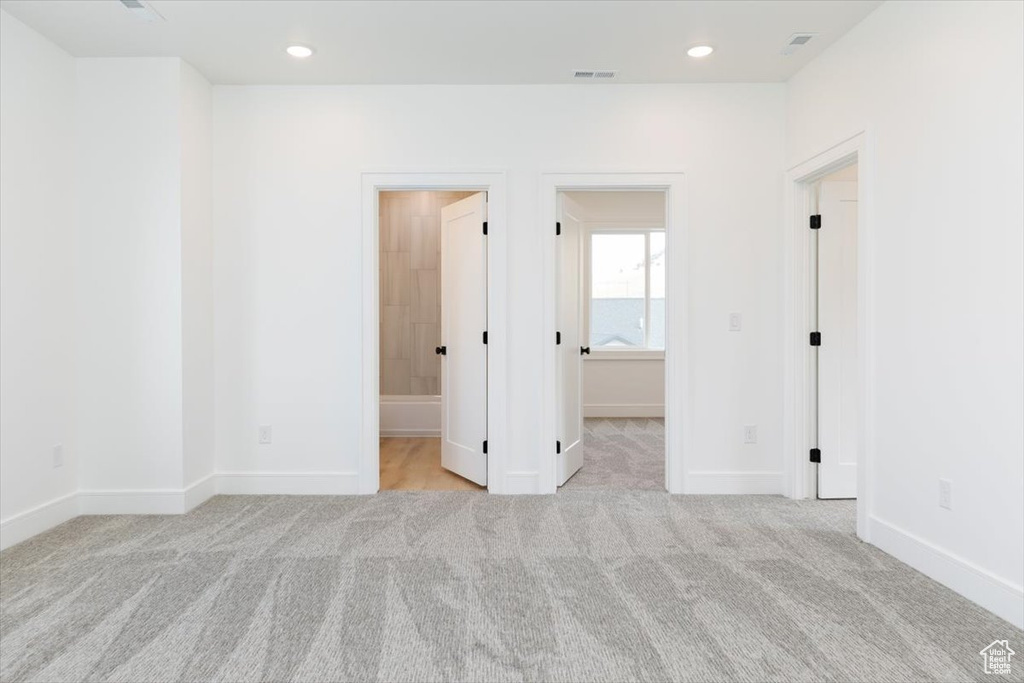 Spare room with light colored carpet