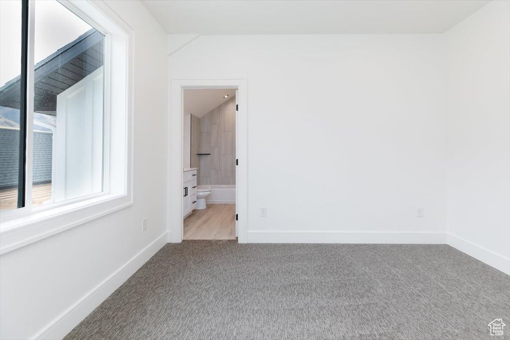 Empty room featuring light colored carpet