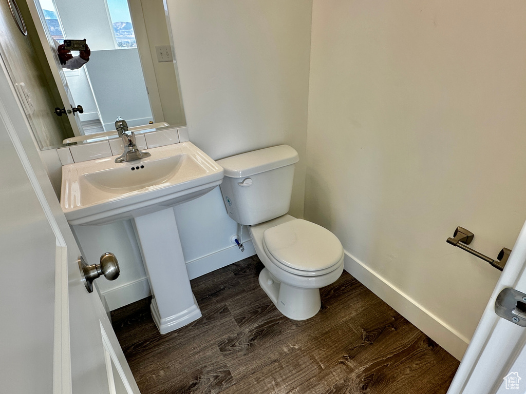 Bathroom with hardwood / wood-style floors and toilet