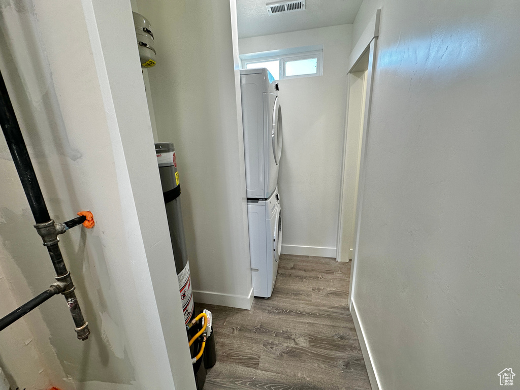 Utility room featuring stacked washer / dryer