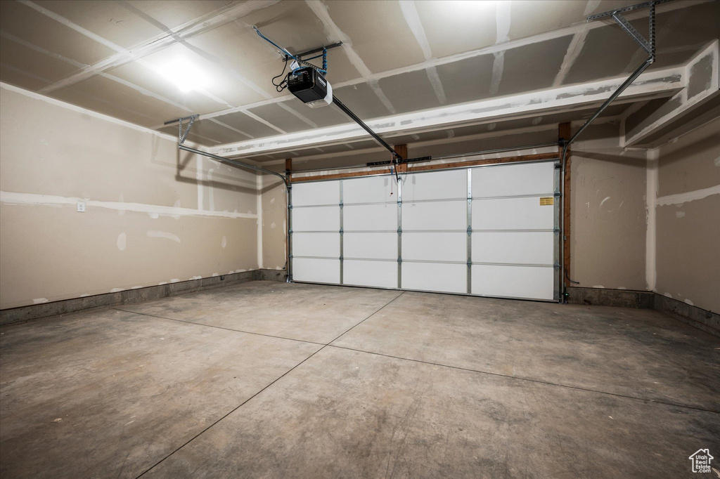 Garage featuring a garage door opener