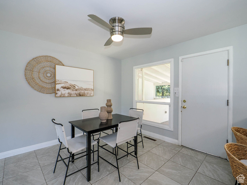 Dining room featuring light tile patterned flooring and ceiling fan