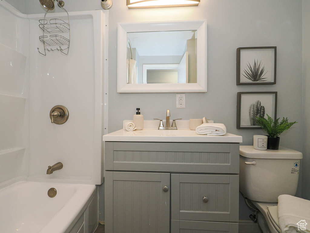 Full bathroom featuring washtub / shower combination, vanity, and toilet