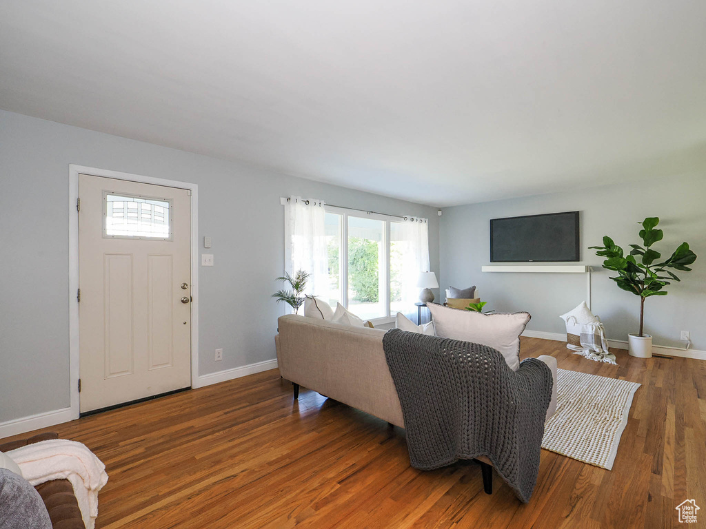 Living room featuring plenty of natural light and dark hardwood / wood-style floors