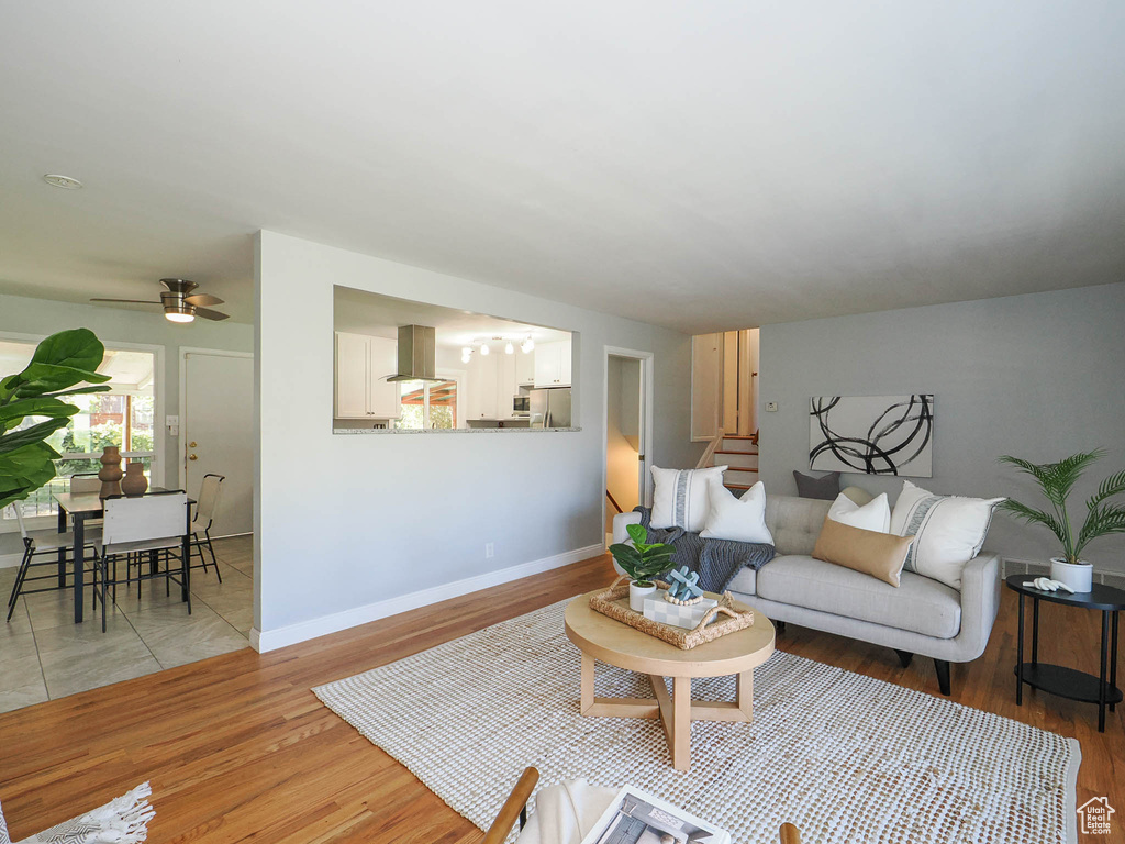 Living room with wood-type flooring and ceiling fan