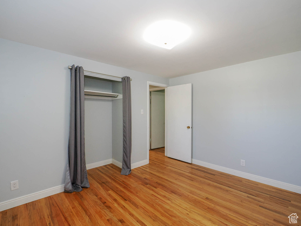 Unfurnished bedroom with a closet and light hardwood / wood-style flooring