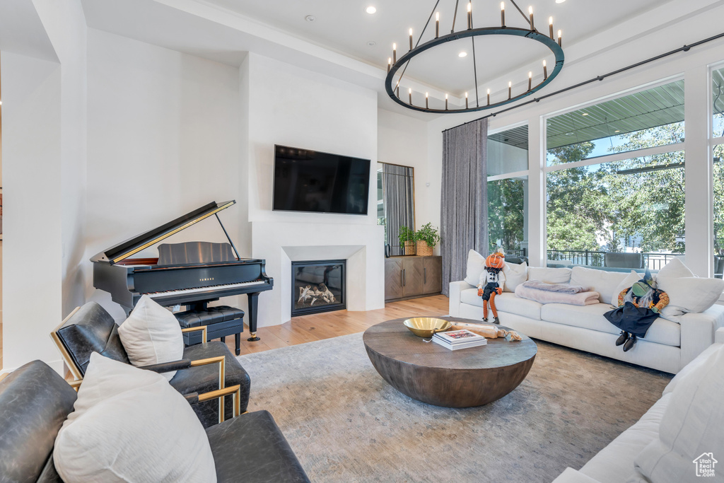 Living room with light wood-type flooring and a chandelier