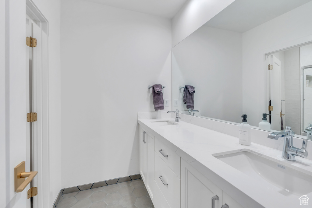 Bathroom featuring tile patterned floors and vanity