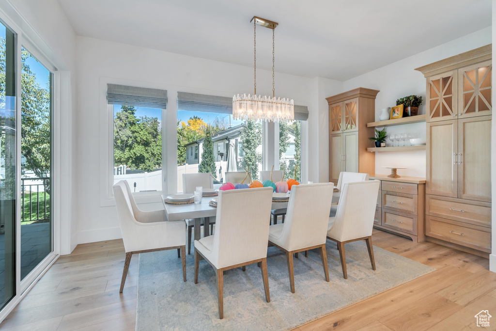 Dining area featuring an inviting chandelier and light hardwood / wood-style floors