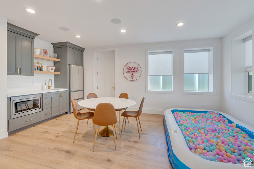 Dining room featuring indoor wet bar and light hardwood / wood-style floors