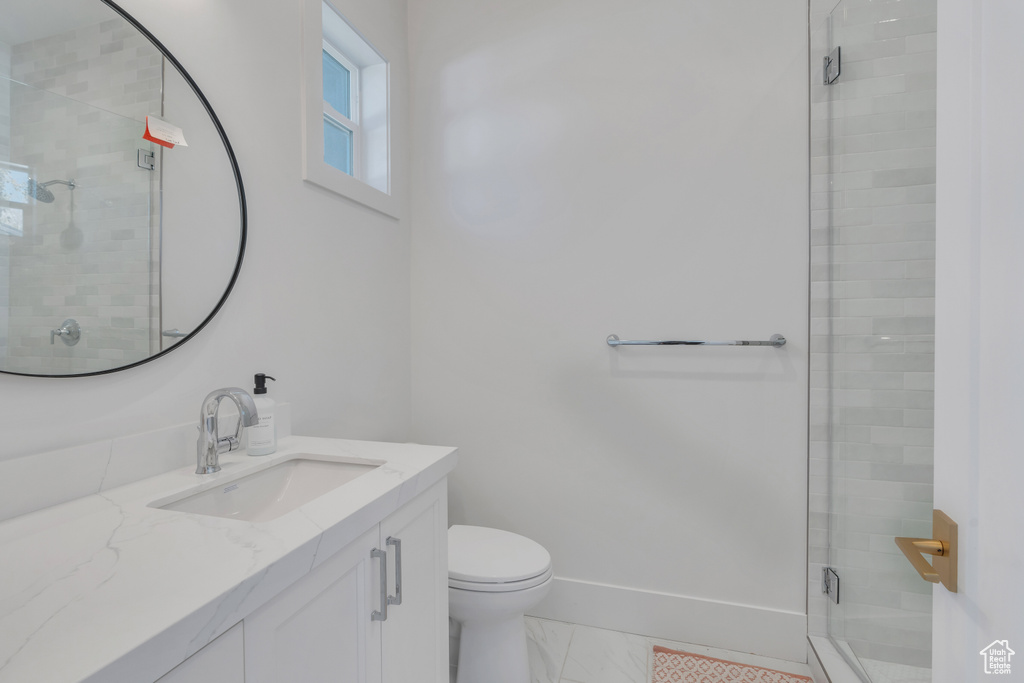 Bathroom with walk in shower, vanity, and toilet