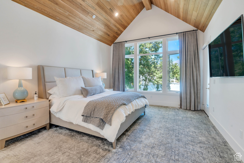 Carpeted bedroom with beam ceiling, high vaulted ceiling, and wooden ceiling