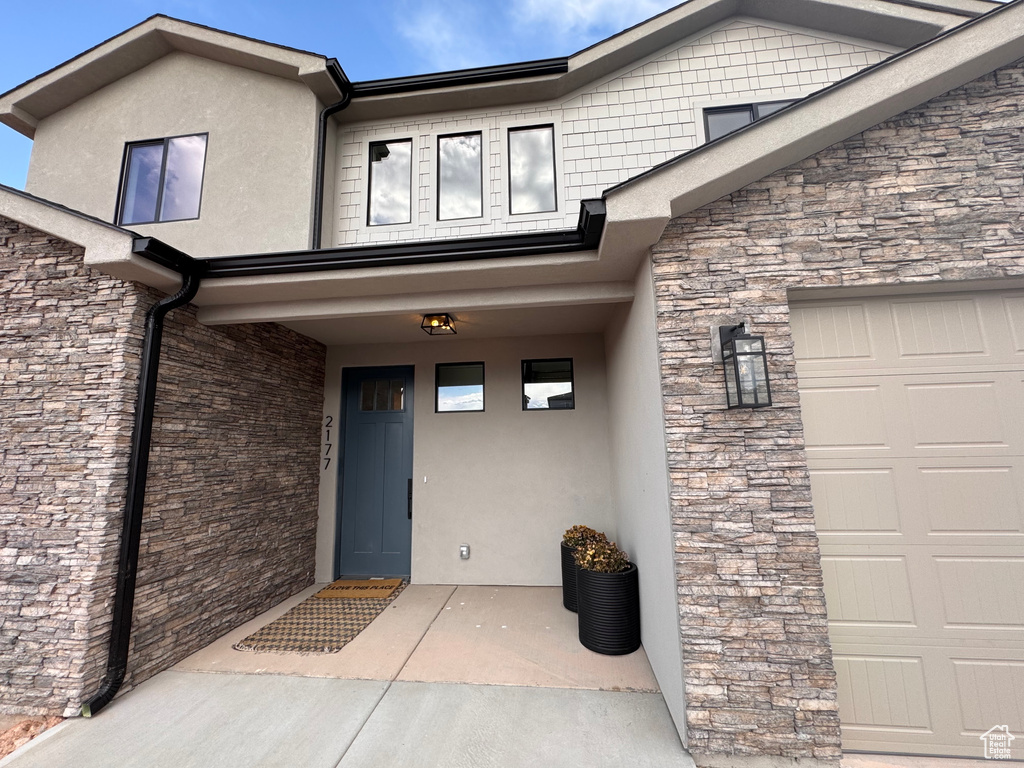 Doorway to property featuring a garage