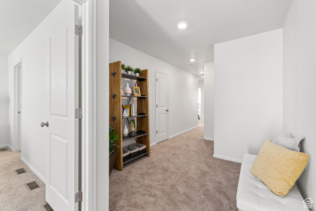 Living area featuring light colored carpet