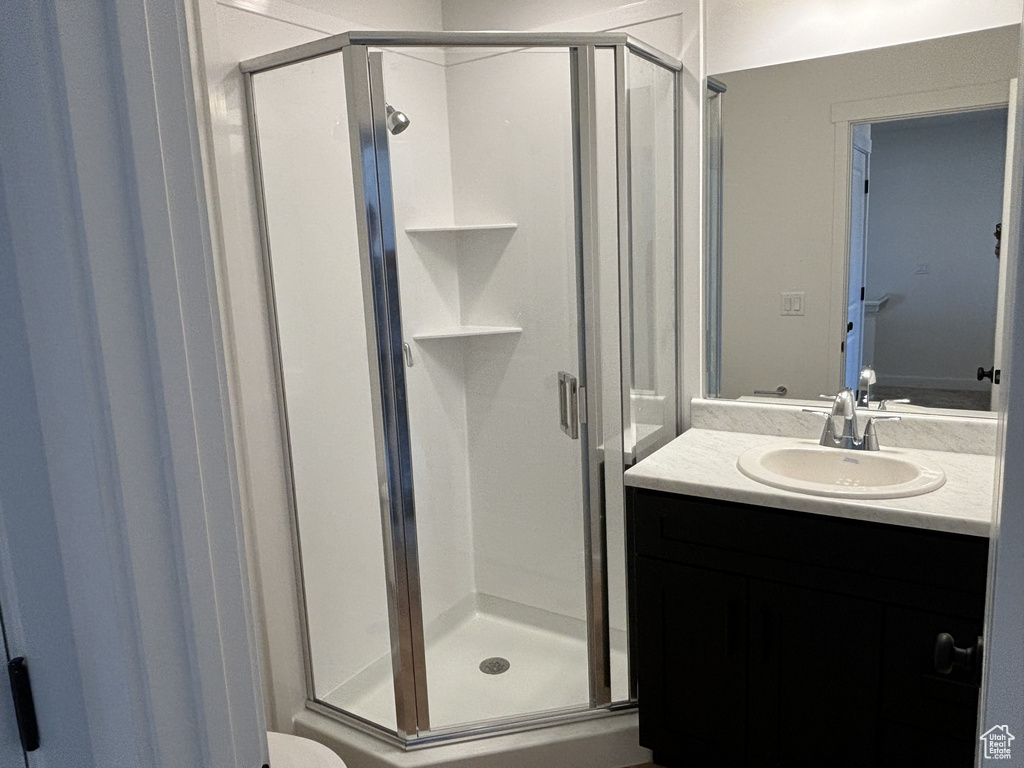 Bathroom featuring vanity and an enclosed shower