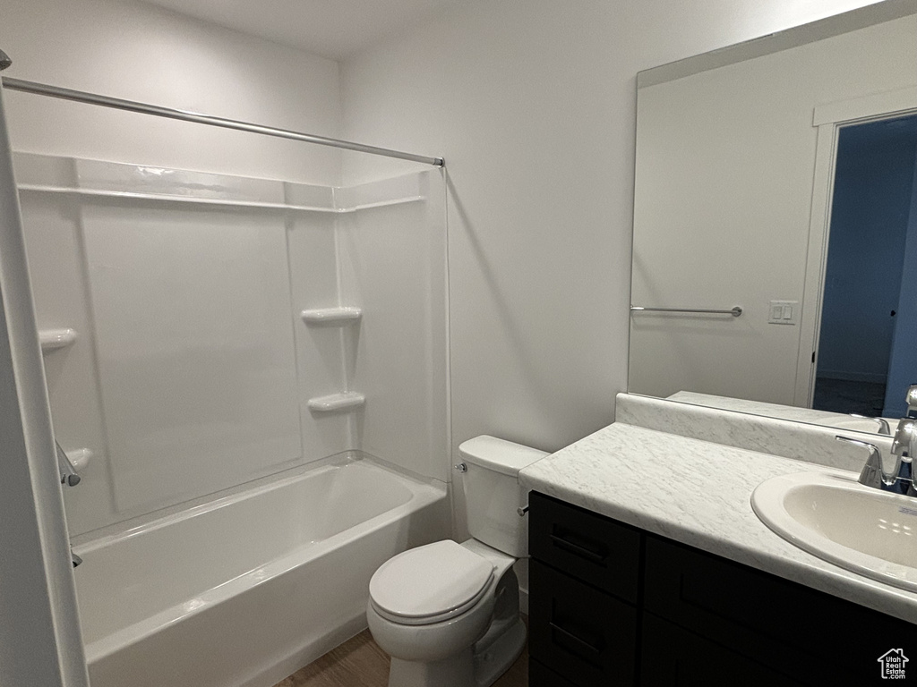 Full bathroom featuring shower / bathing tub combination, vanity, and toilet