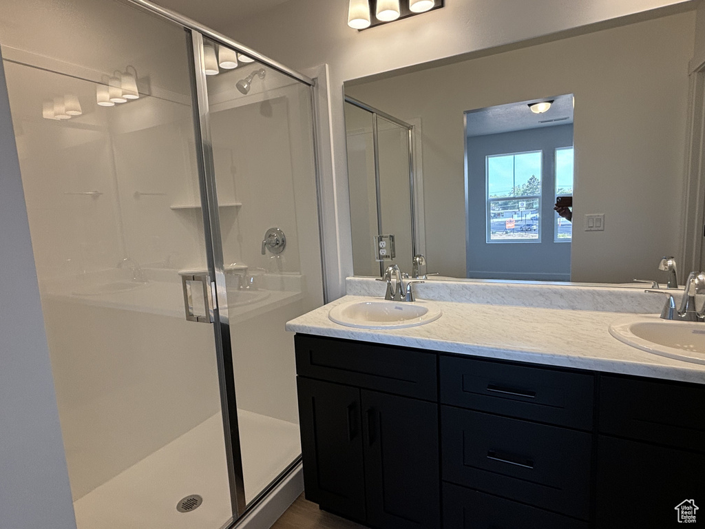 Bathroom with an enclosed shower and vanity