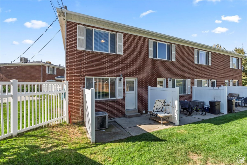 Back of property featuring a yard, a patio area, and central AC unit