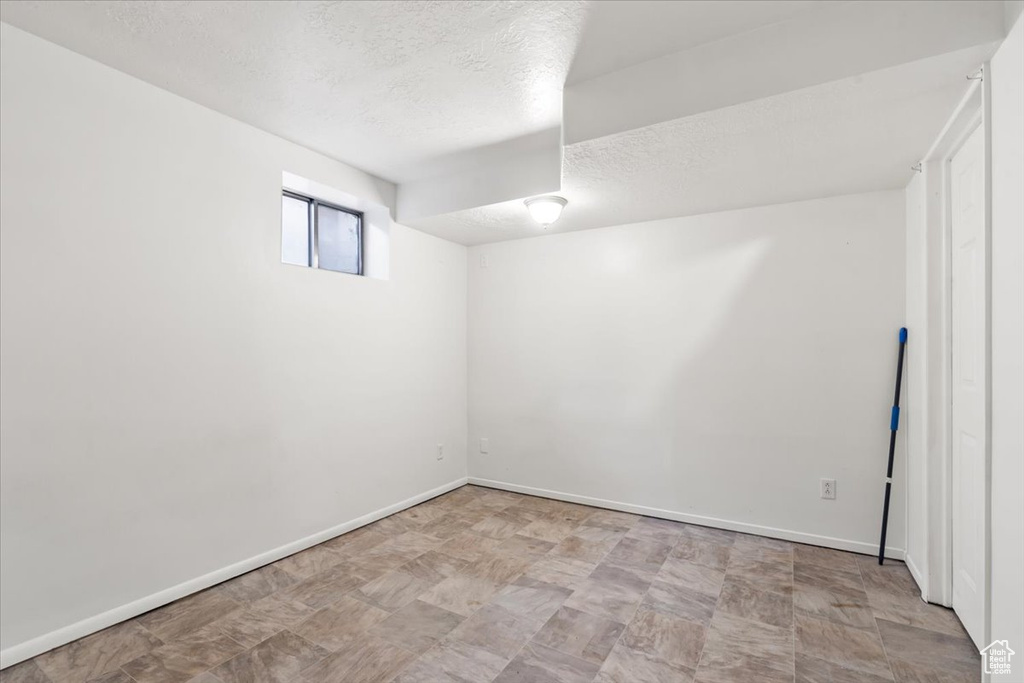 Basement with a textured ceiling