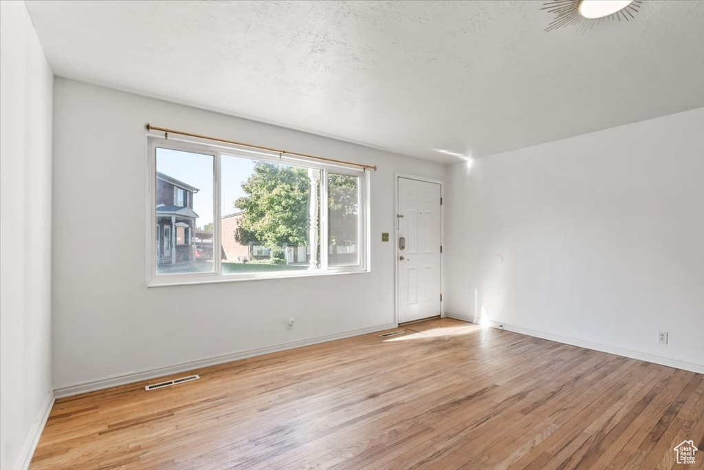 Unfurnished room with light hardwood / wood-style flooring