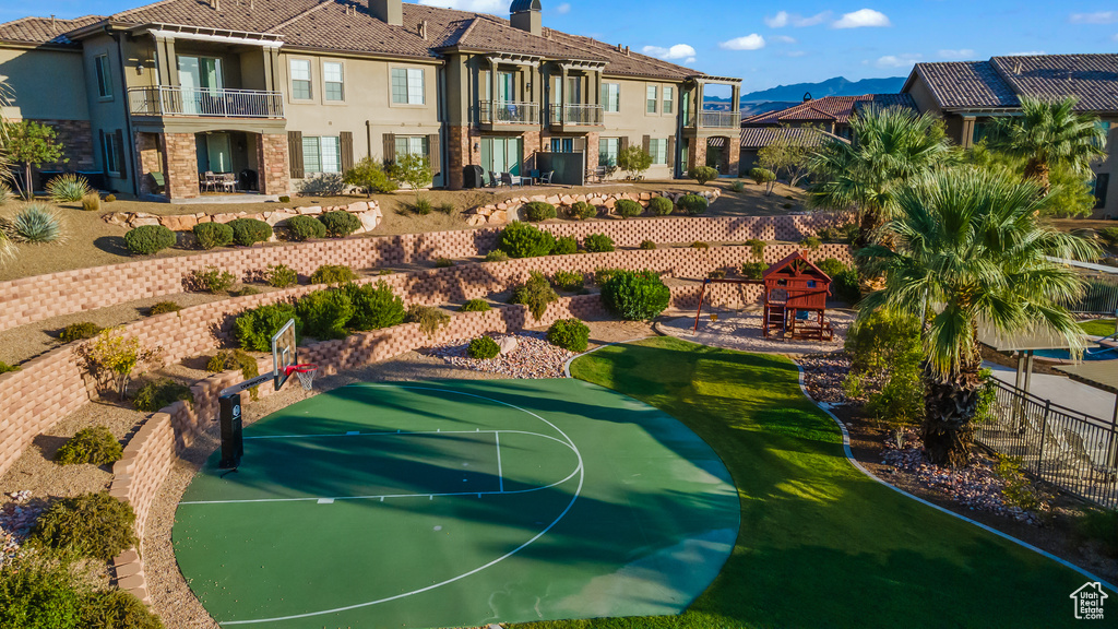 View of basketball court with a playground and a mountain view