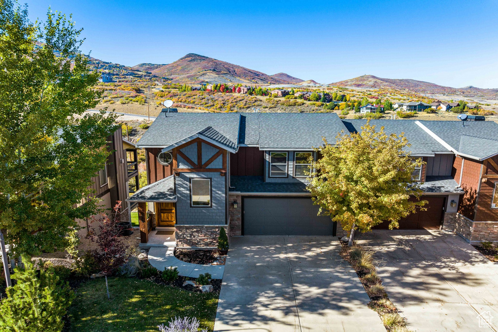 View of front of property featuring a mountain view and a garage