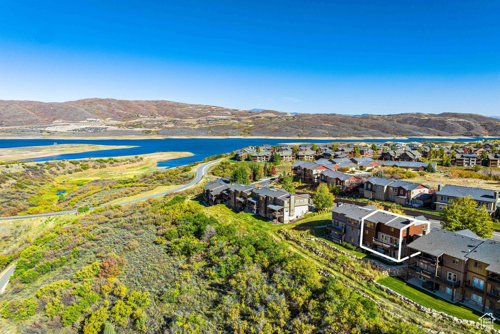 Birds eye view of property with a water and mountain view