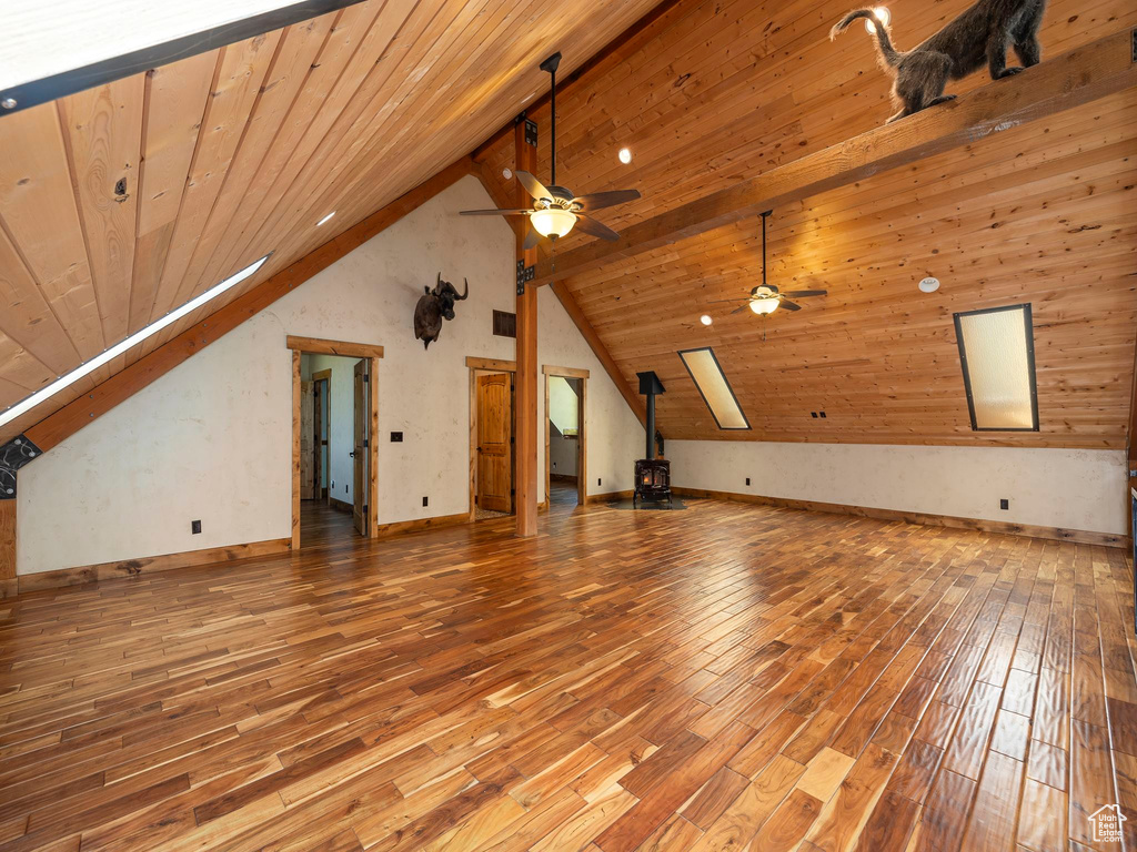 Bonus room with wood-type flooring, wooden ceiling, beam ceiling, and ceiling fan