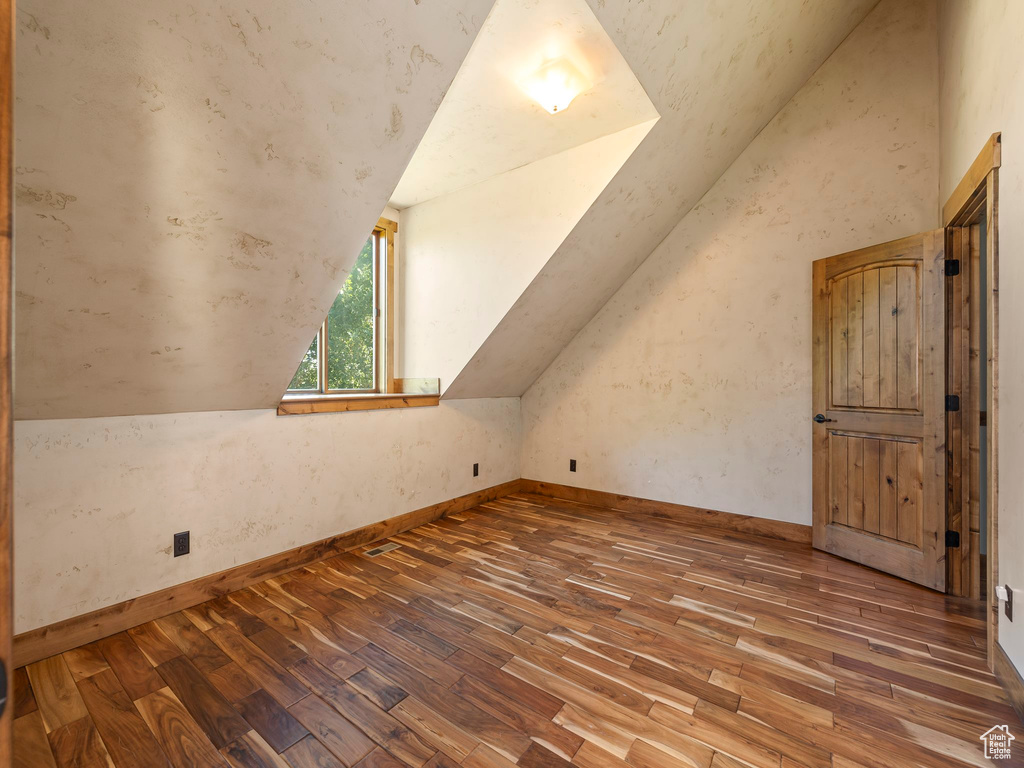 Additional living space featuring lofted ceiling and hardwood / wood-style floors