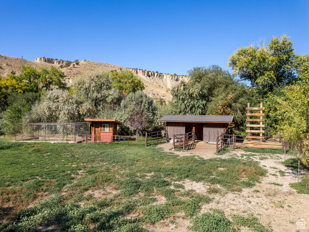 View of yard with an outbuilding, a mountain view, and a rural view