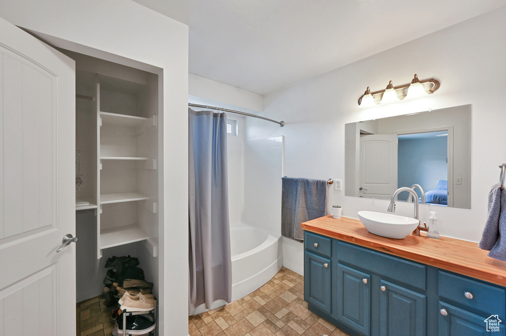 Bathroom featuring shower / bath combo and vanity