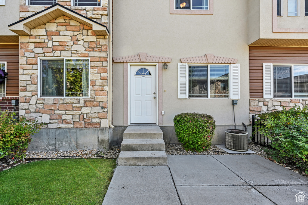 Property entrance featuring cooling unit