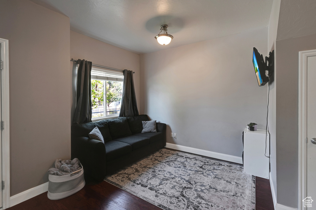 Living area featuring dark wood-type flooring