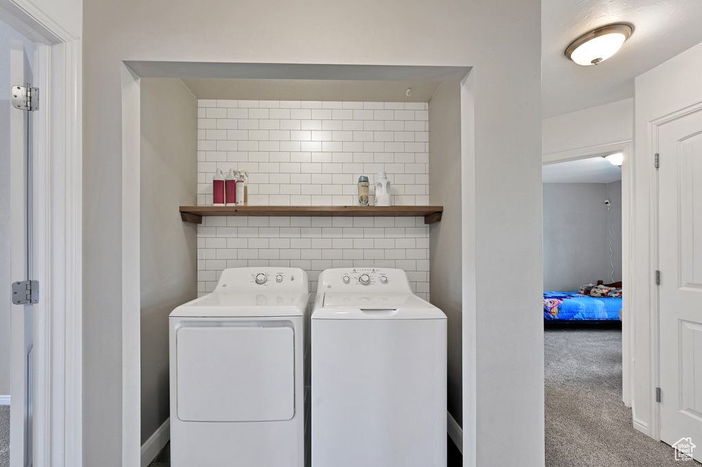 Laundry room featuring washing machine and dryer and carpet