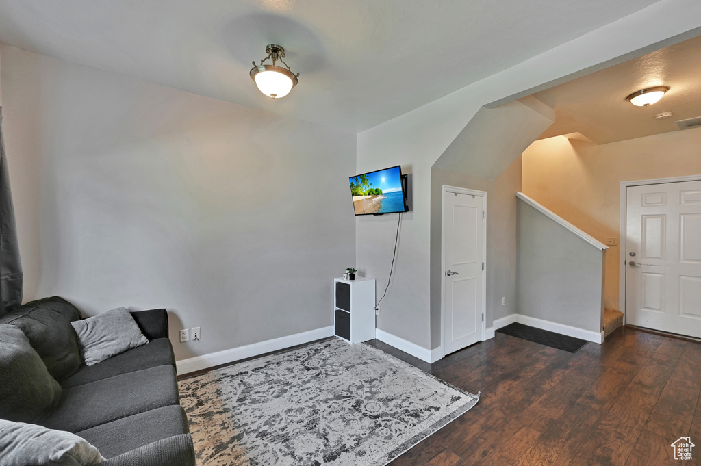 Living room with dark hardwood / wood-style floors