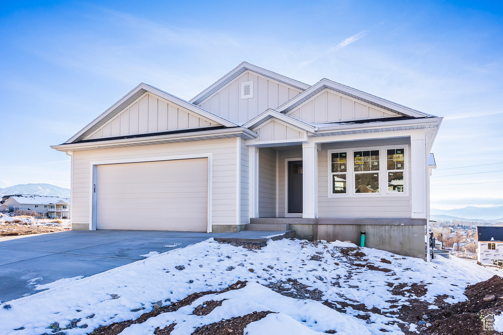 View of front of house featuring a mountain view and a garage