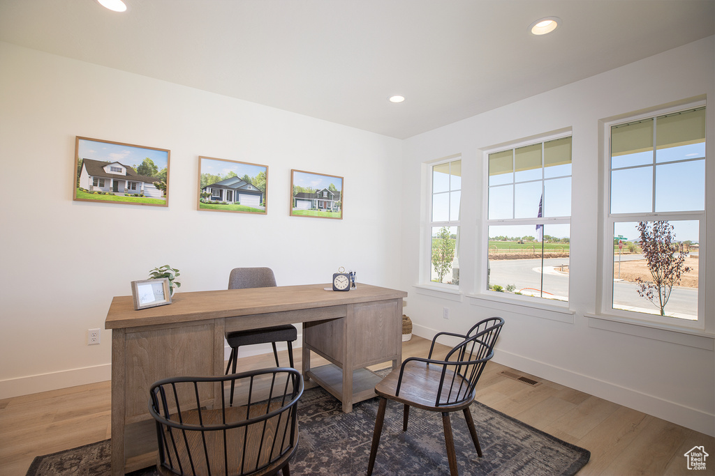 Office space with hardwood / wood-style flooring