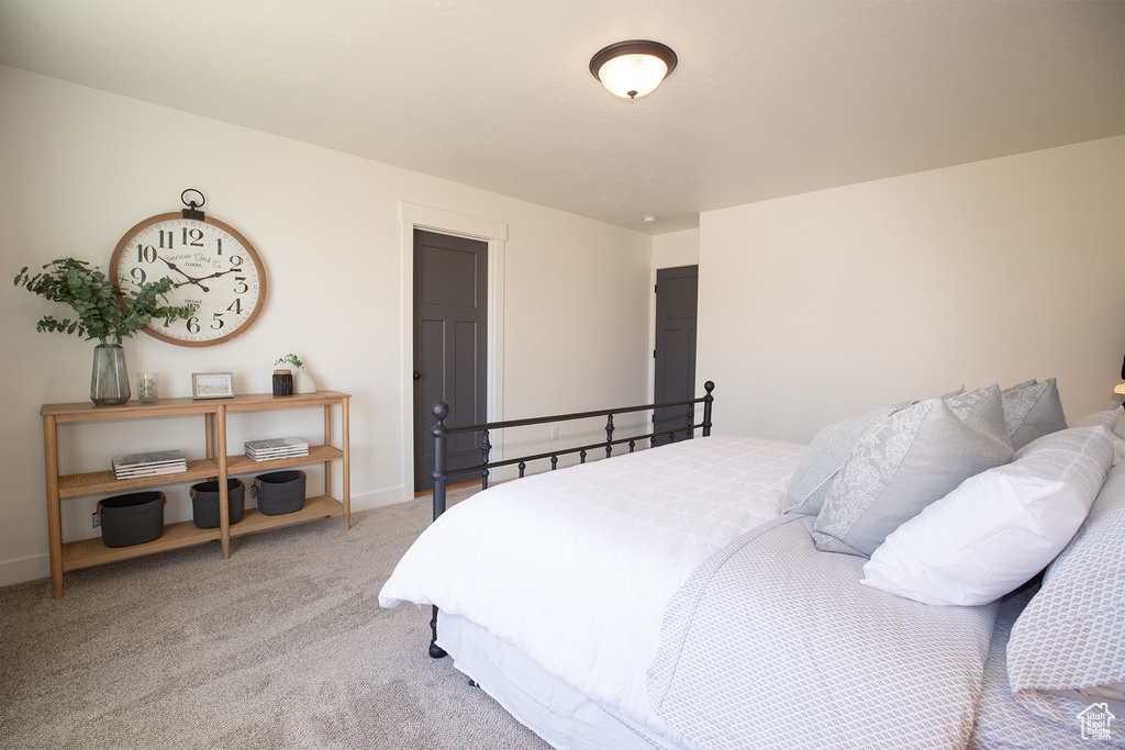 Bedroom with light colored carpet