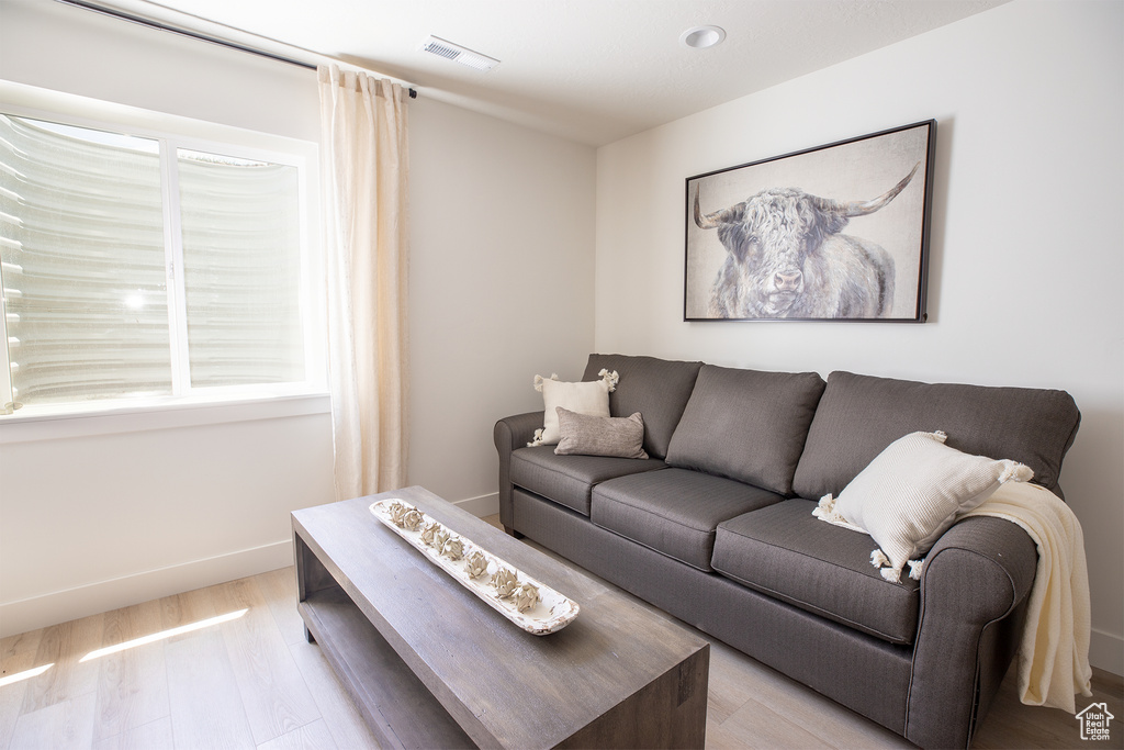 Living room with light hardwood / wood-style floors